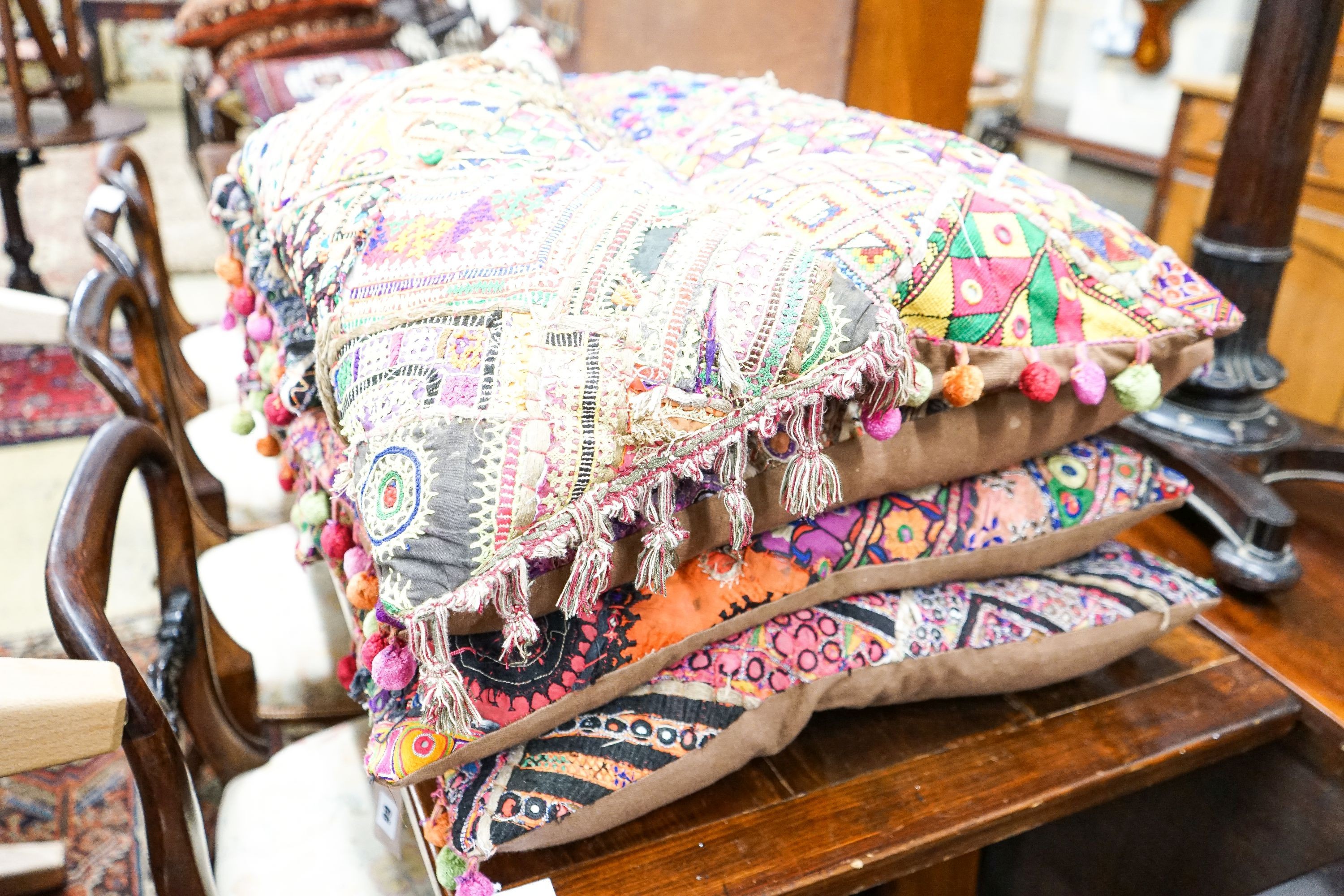 Eight Indian embroidered cushions, 60 x 30cm